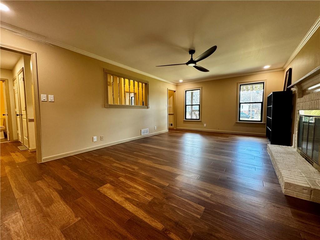 1709 Rangewood Drive Southwest Lilburn, GA 30047 - Photo 11 of 52 a view of an empty room with wooden floor and a window