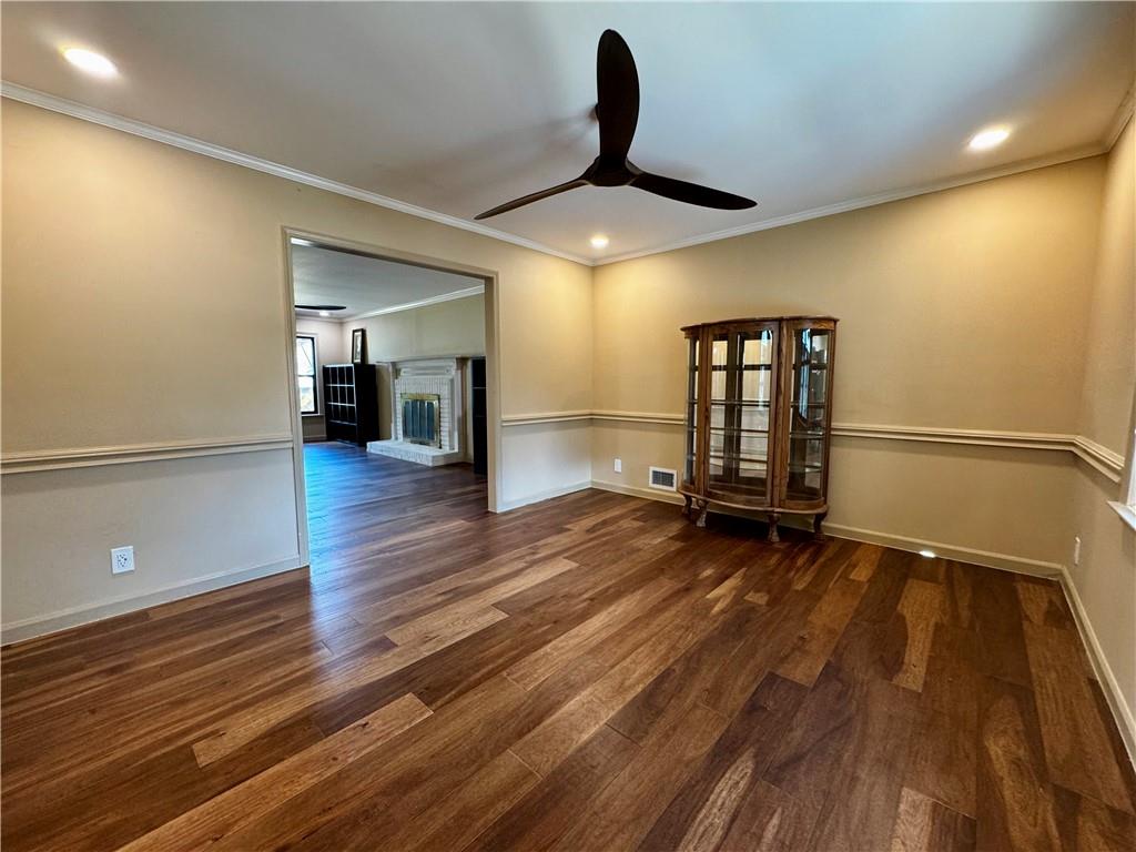 1709 Rangewood Drive Southwest Lilburn, GA 30047 - Photo 13 of 52 a view of empty room with wooden floor and fan
