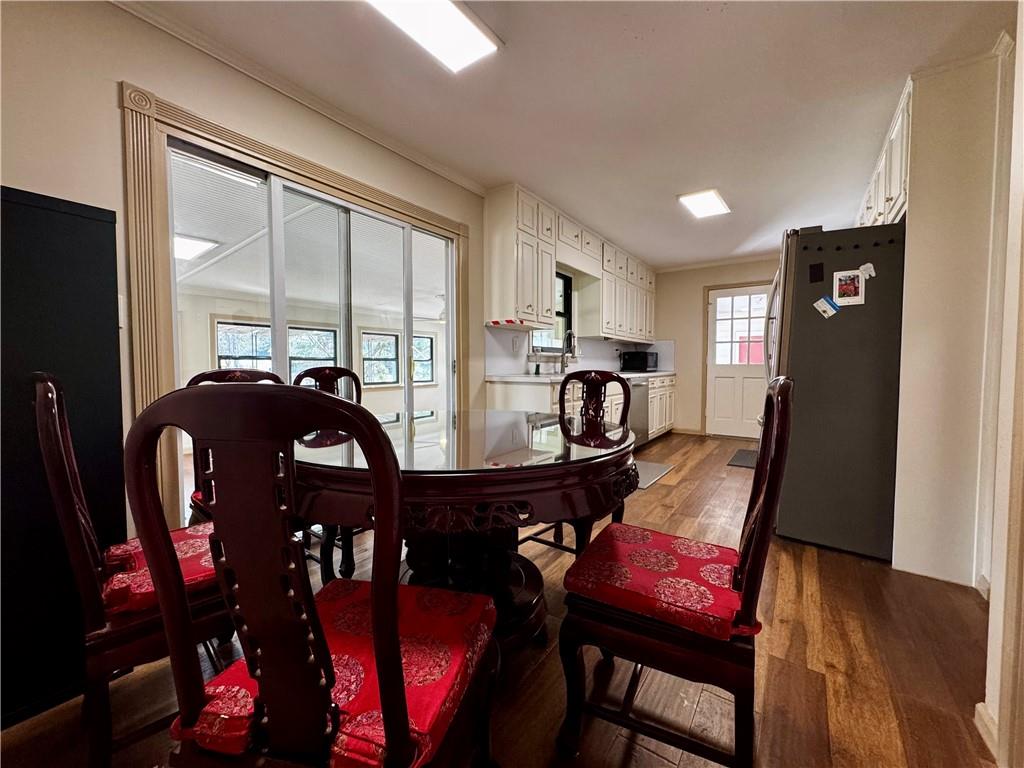 1709 Rangewood Drive Southwest Lilburn, GA 30047 - Photo 16 of 52 a view of a dining room with furniture window and wooden floor