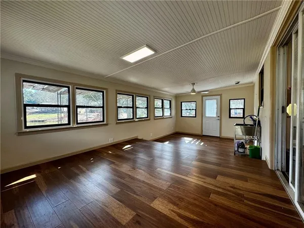 wooden floor in an empty room with a window