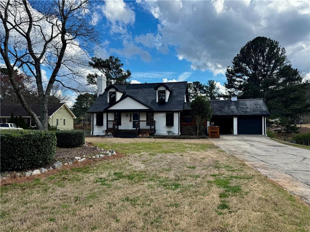 1709 Rangewood Drive Southwest Lilburn, GA 30047 - Photo 2 of 52 a front view of a house with a garden