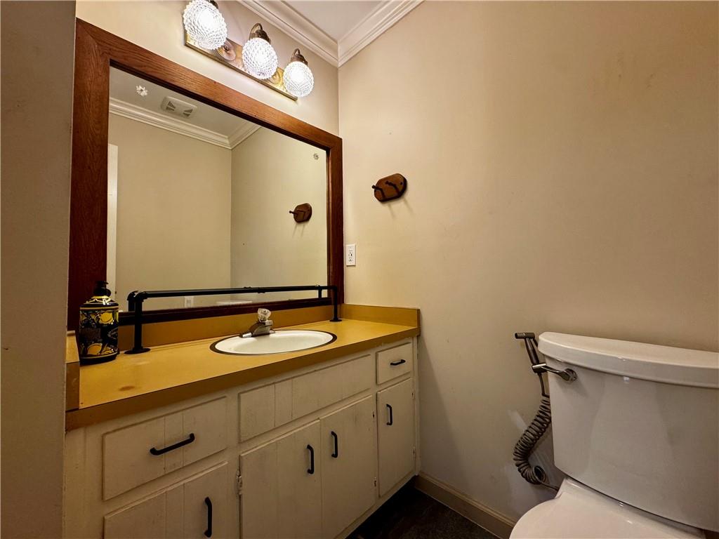 1709 Rangewood Drive Southwest Lilburn, GA 30047 - Photo 25 of 52 a bathroom with a granite countertop sink toilet and mirror