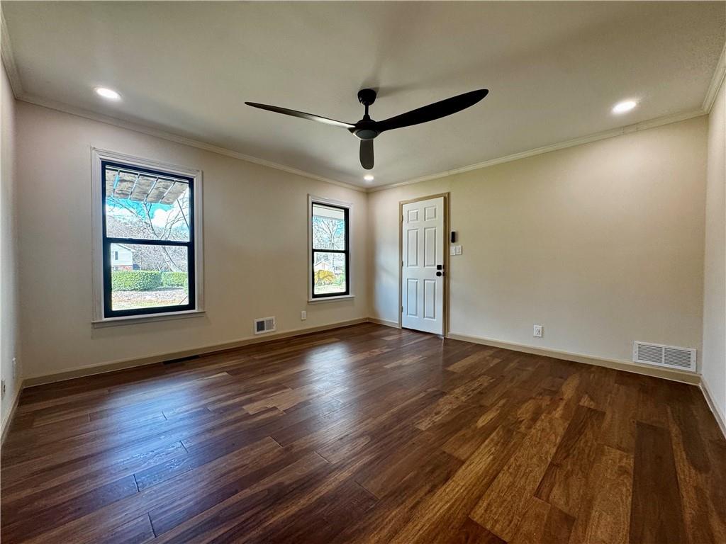 1709 Rangewood Drive Southwest Lilburn, GA 30047 - Photo 29 of 52 a view of empty room with wooden floor and fan