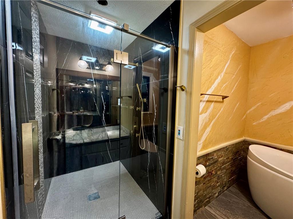 1709 Rangewood Drive Southwest Lilburn, GA 30047 - Photo 33 of 52 a bathroom with a granite countertop sink a toilet and shower