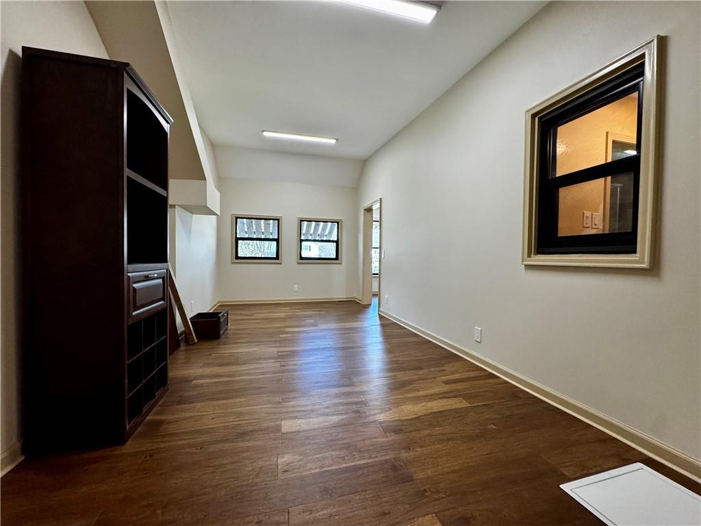 1709 Rangewood Drive Southwest Lilburn, GA 30047 - Photo 36 of 52 an empty room with wooden floor and windows