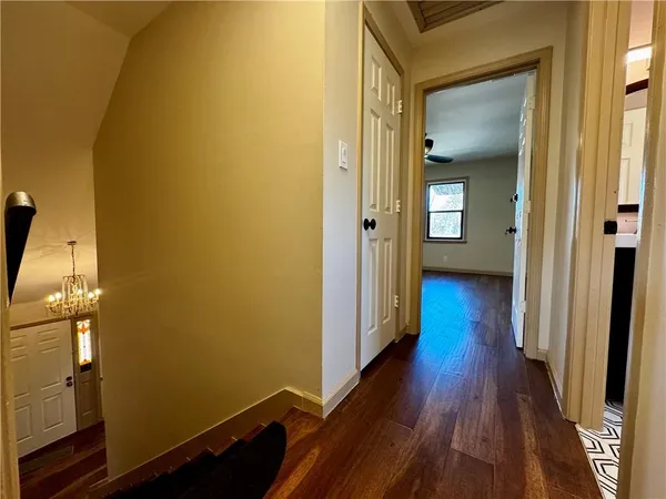 a view of an empty room and wooden floor