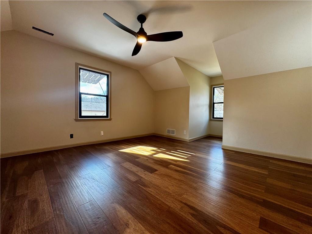 1709 Rangewood Drive Southwest Lilburn, GA 30047 - Photo 41 of 52 a view of empty room with wooden floor and fan