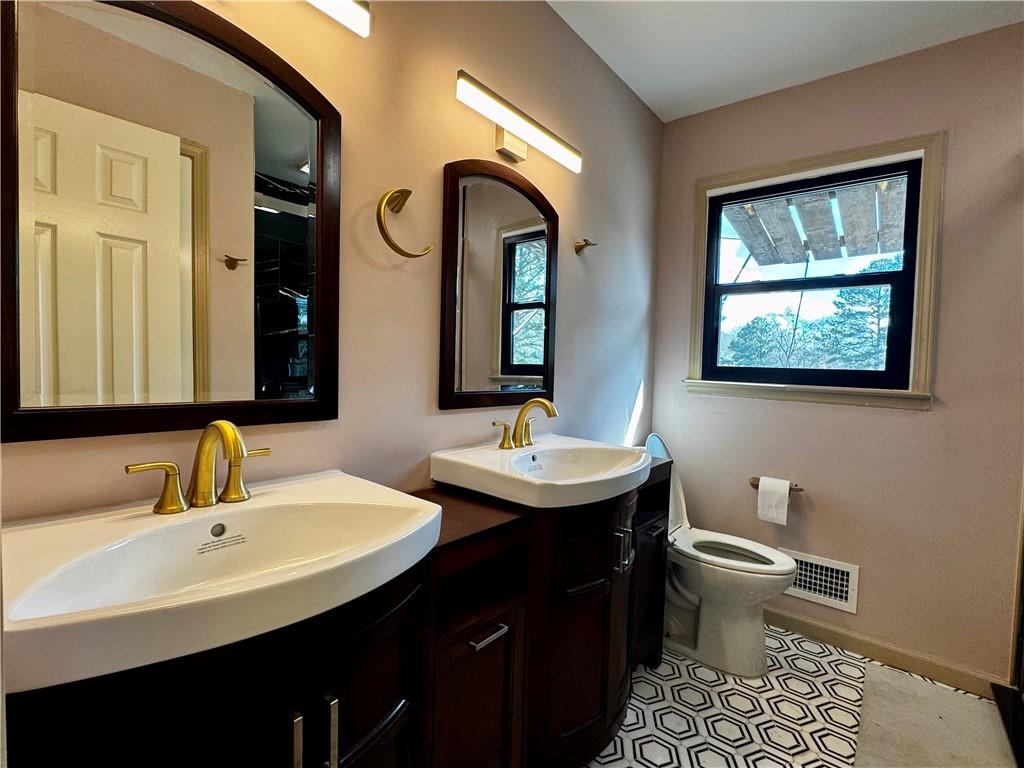 1709 Rangewood Drive Southwest Lilburn, GA 30047 - Photo 42 of 52 a bathroom with 2 sink and a mirror