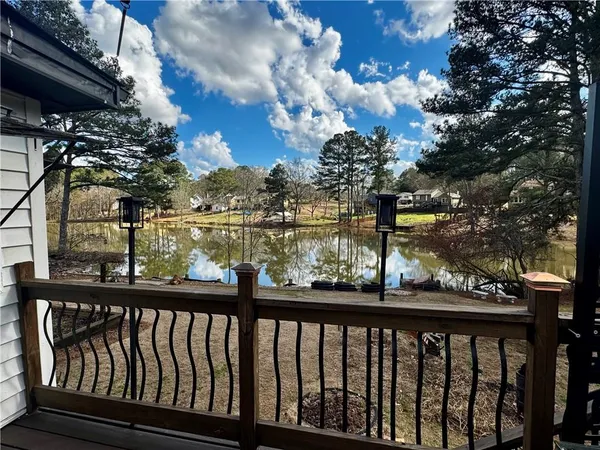 a view of a balcony with wooden floor and furniture