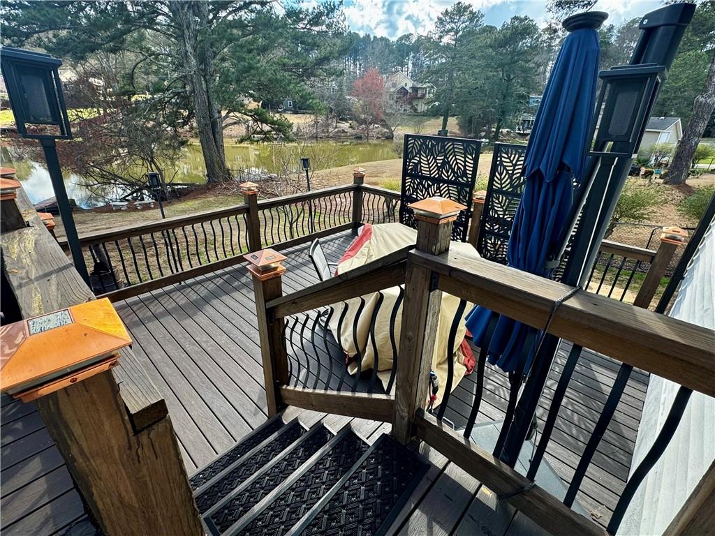 1709 Rangewood Drive Southwest Lilburn, GA 30047 - Photo 49 of 52 a view of a balcony with wooden floor and furniture