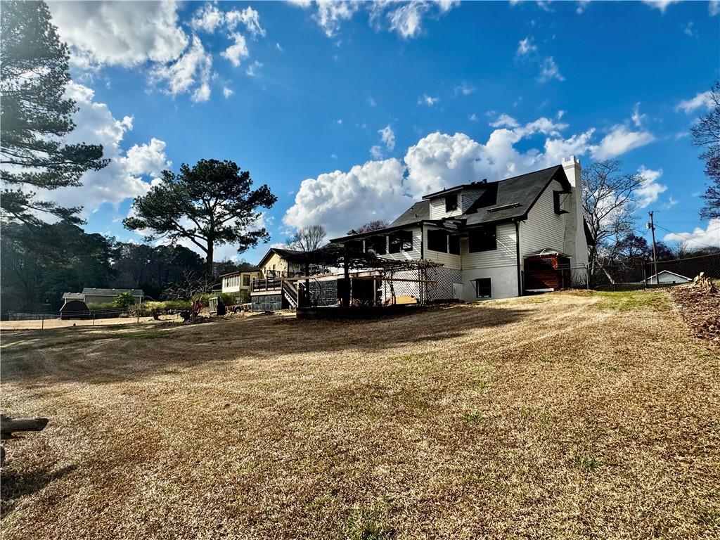 1709 Rangewood Drive Southwest Lilburn, GA 30047 - Photo 51 of 52 a front view of a house with a yard covered with snow