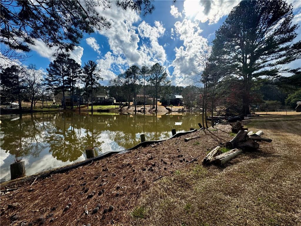 1709 Rangewood Drive Southwest Lilburn, GA 30047 - Photo 6 of 52 a view of a lake with a yard