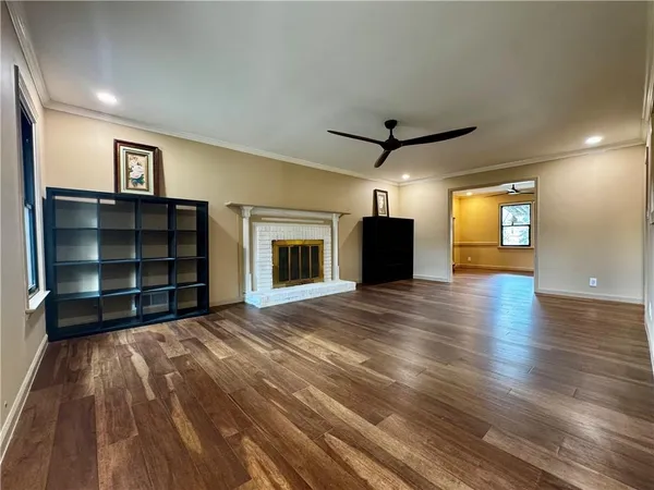 a view of an empty room with a fireplace and a window