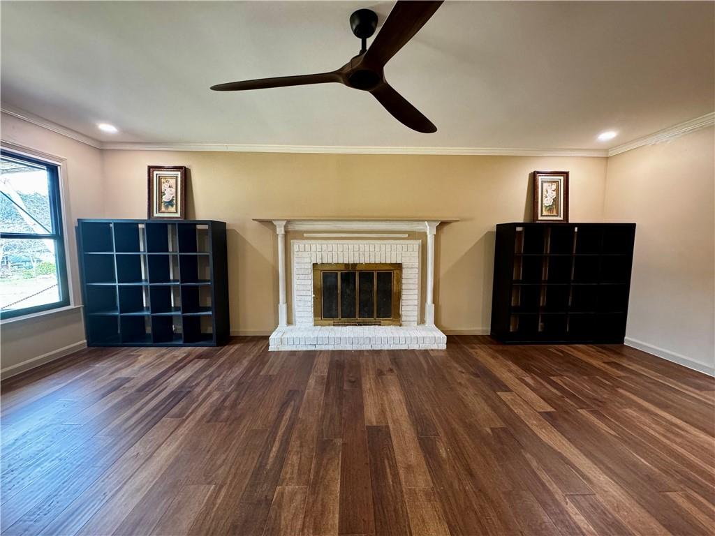 1709 Rangewood Drive Southwest Lilburn, GA 30047 - Photo 10 of 52 a view of an empty room with wooden floor fireplace and a window