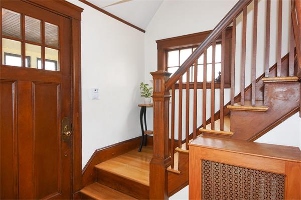 91 Ronald Road Arlington, MA 02474 - Photo 12 of 26 a view of staircase with lots of frames on wall and a window