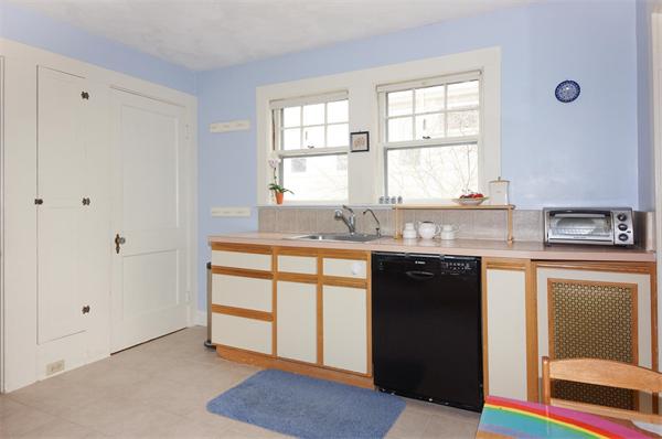 91 Ronald Road Arlington, MA 02474 - Photo 15 of 26 a kitchen with granite countertop a sink cabinets and window