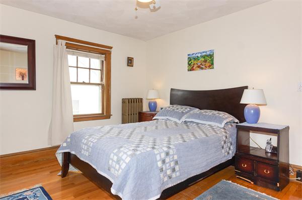 91 Ronald Road Arlington, MA 02474 - Photo 6 of 26 a bedroom with a bed and wooden floor