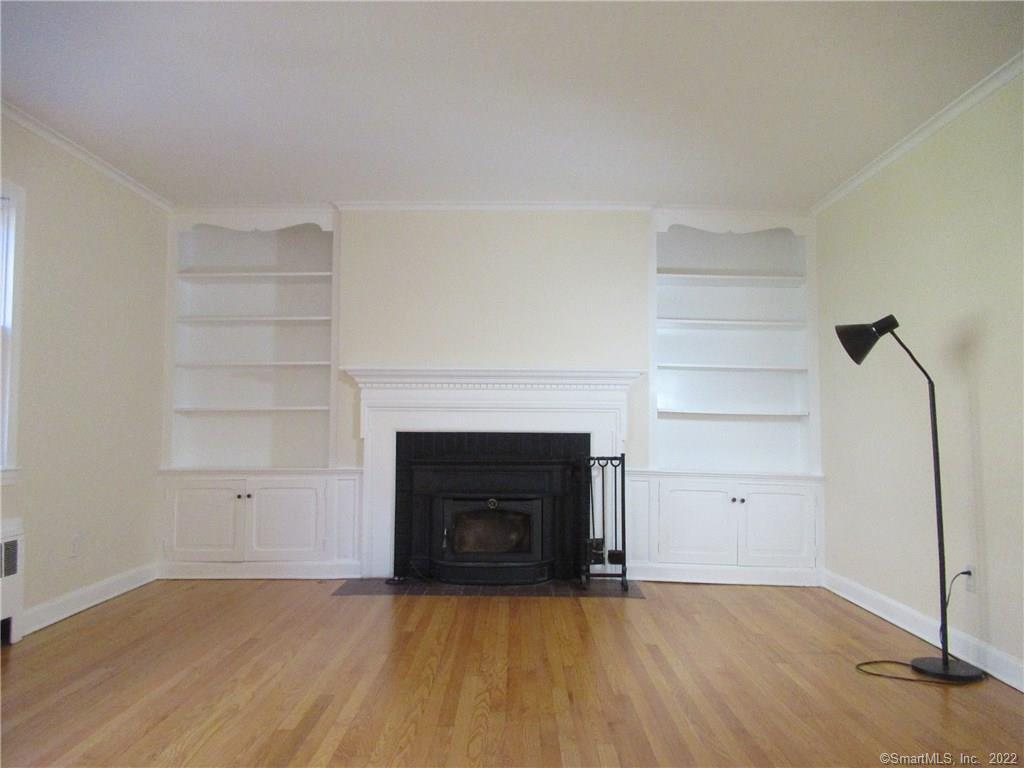 11 Burnt Swamp Road Woodbridge, CT 06525 - Photo 7 of 29 a view of empty room with a fireplace and wooden floor