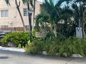 a couple of palm trees in front of a house
