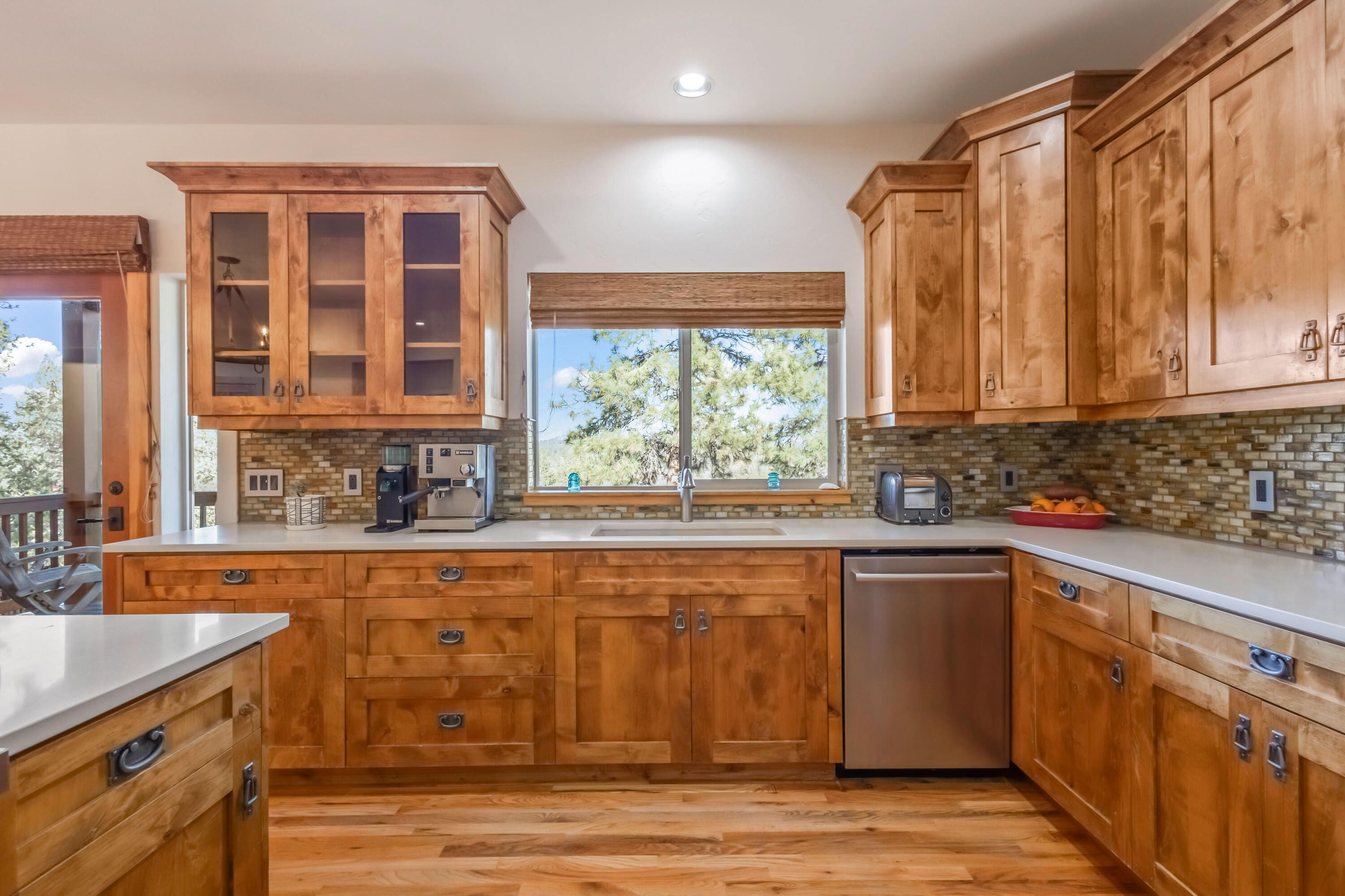 69590 Omaha Road Sisters, OR 97759 - Photo 15 of 46 a kitchen with stainless steel appliances granite countertop a stove a sink and a microwave