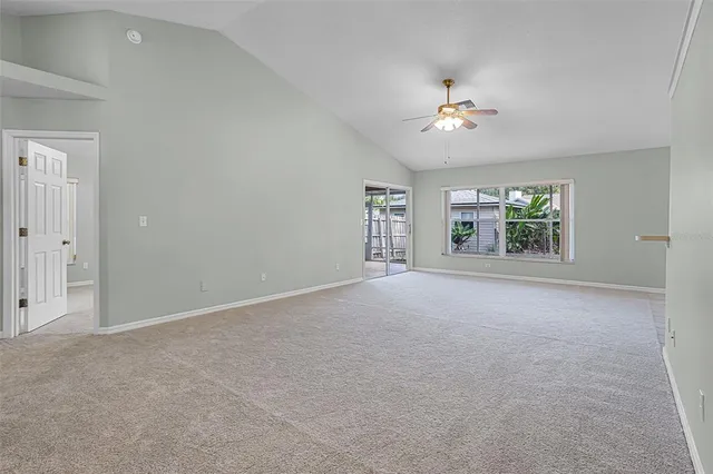 an empty room with chandelier fan