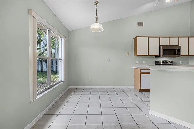 a view of a kitchen with a sink and a refrigerator