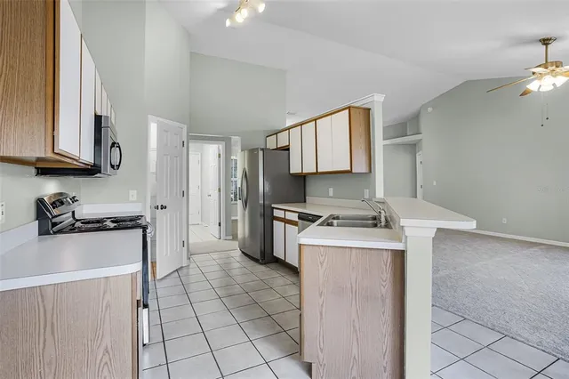 a kitchen with stainless steel appliances granite countertop a stove a microwave and a sink