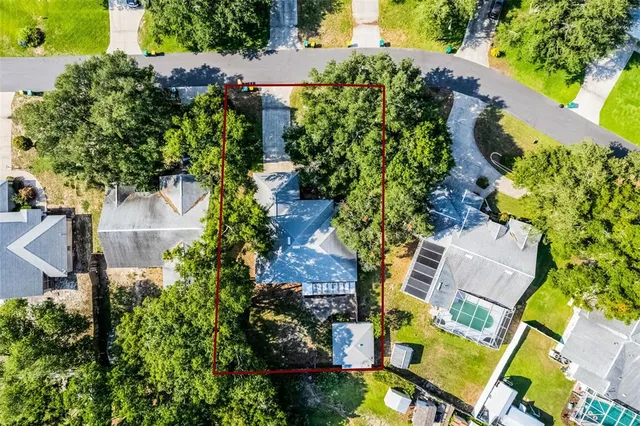 an aerial view of residential house with outdoor space and swimming pool