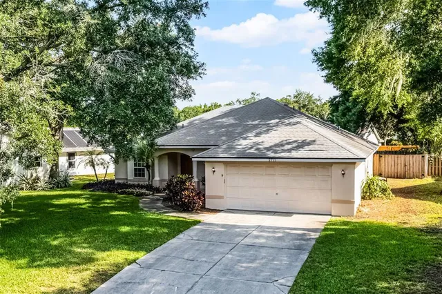 a front view of house a yard with trees