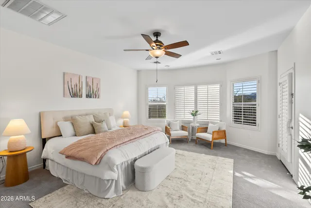 a bedroom with a large bed and a chandelier