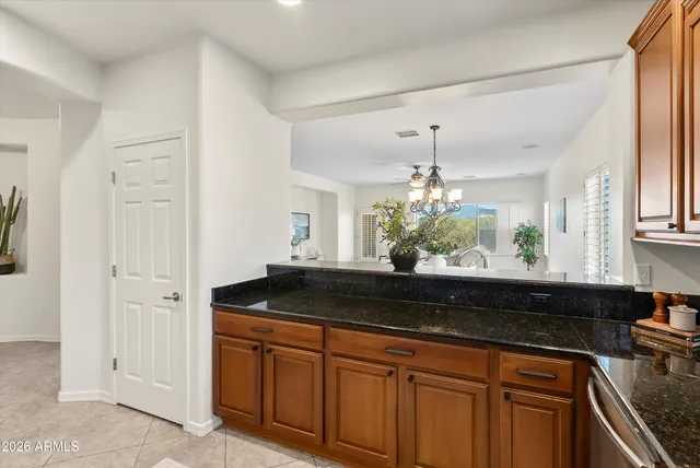 a kitchen with granite countertop a sink and cabinets