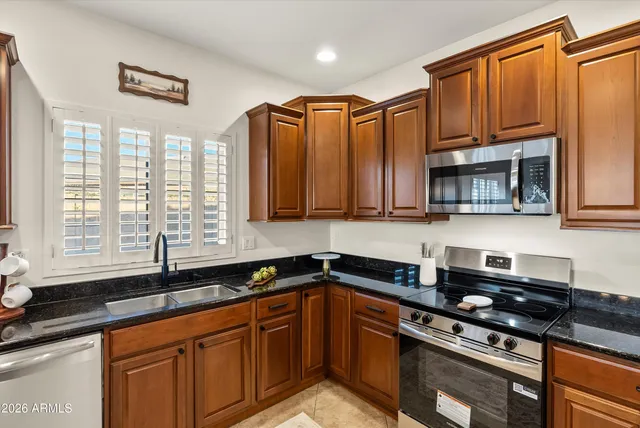 a view of a kitchen counter space a sink and cabinets