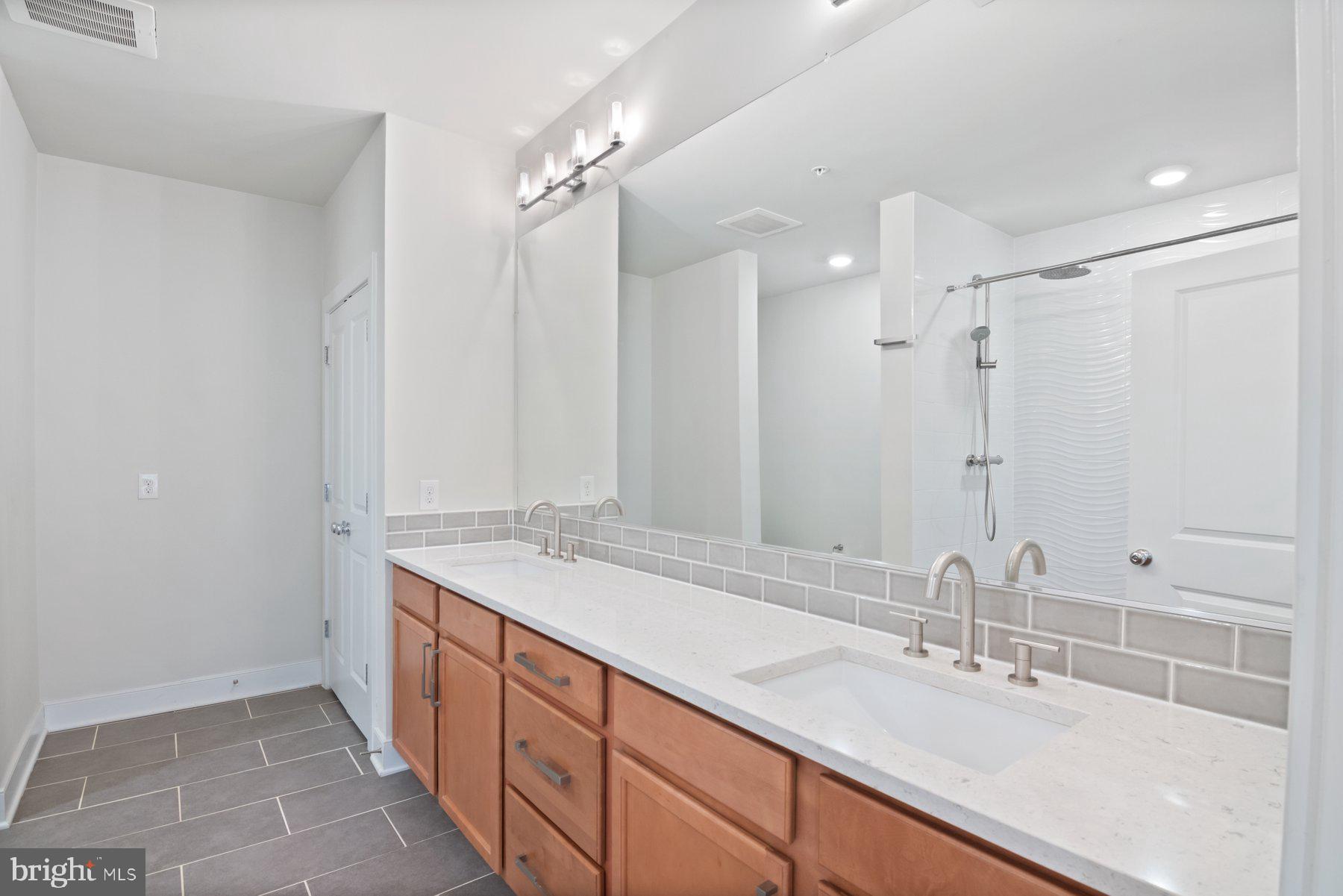 2907 Bleeker Street, Unit 204 Fairfax, VA 22031 - Photo 14 of 20 a bathroom with a sink double vanity and a mirror