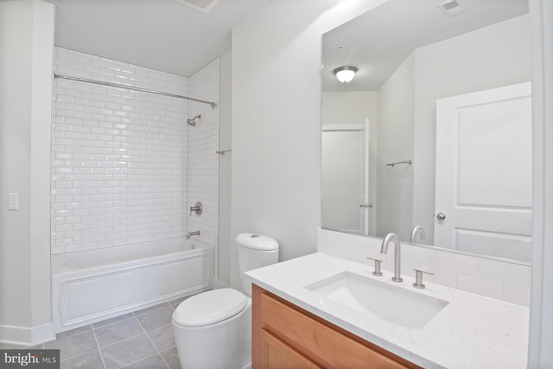 2907 Bleeker Street, Unit 204 Fairfax, VA 22031 - Photo 17 of 20 a bathroom with a sink a toilet and shower