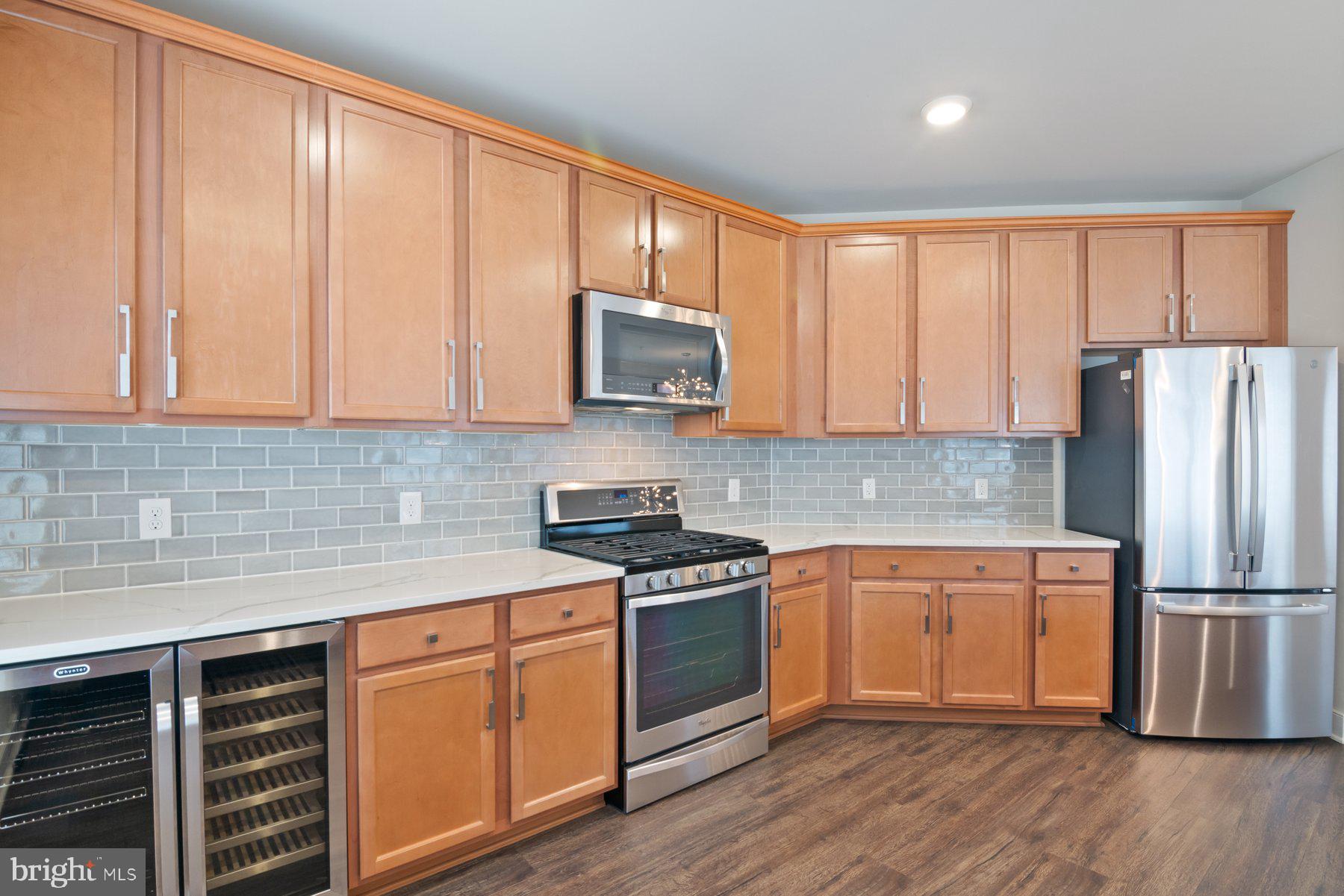 2907 Bleeker Street, Unit 204 Fairfax, VA 22031 - Photo 7 of 20 a kitchen with wooden cabinets and stainless steel appliances