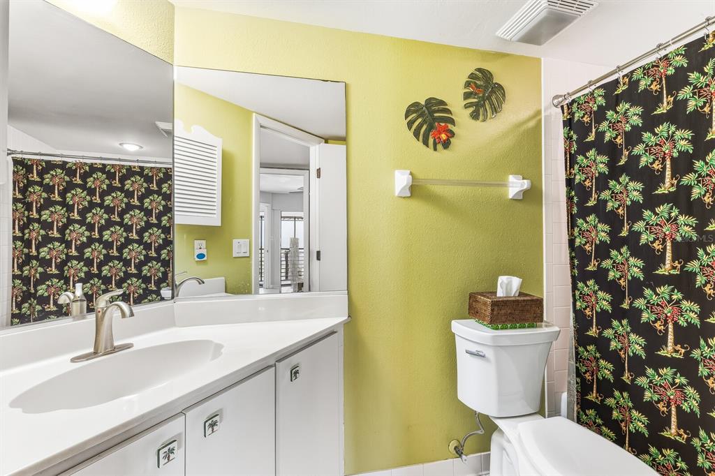 5000 Gasparilla Road, Unit BC103 Boca Grande, FL 33921 - Photo 11 of 36 a bathroom with a sink and a mirror