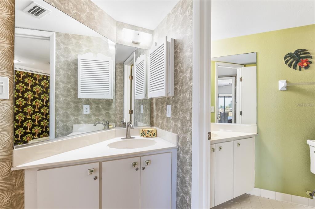 5000 Gasparilla Road, Unit BC103 Boca Grande, FL 33921 - Photo 10 of 36 a bathroom with a sink a mirror and a shower