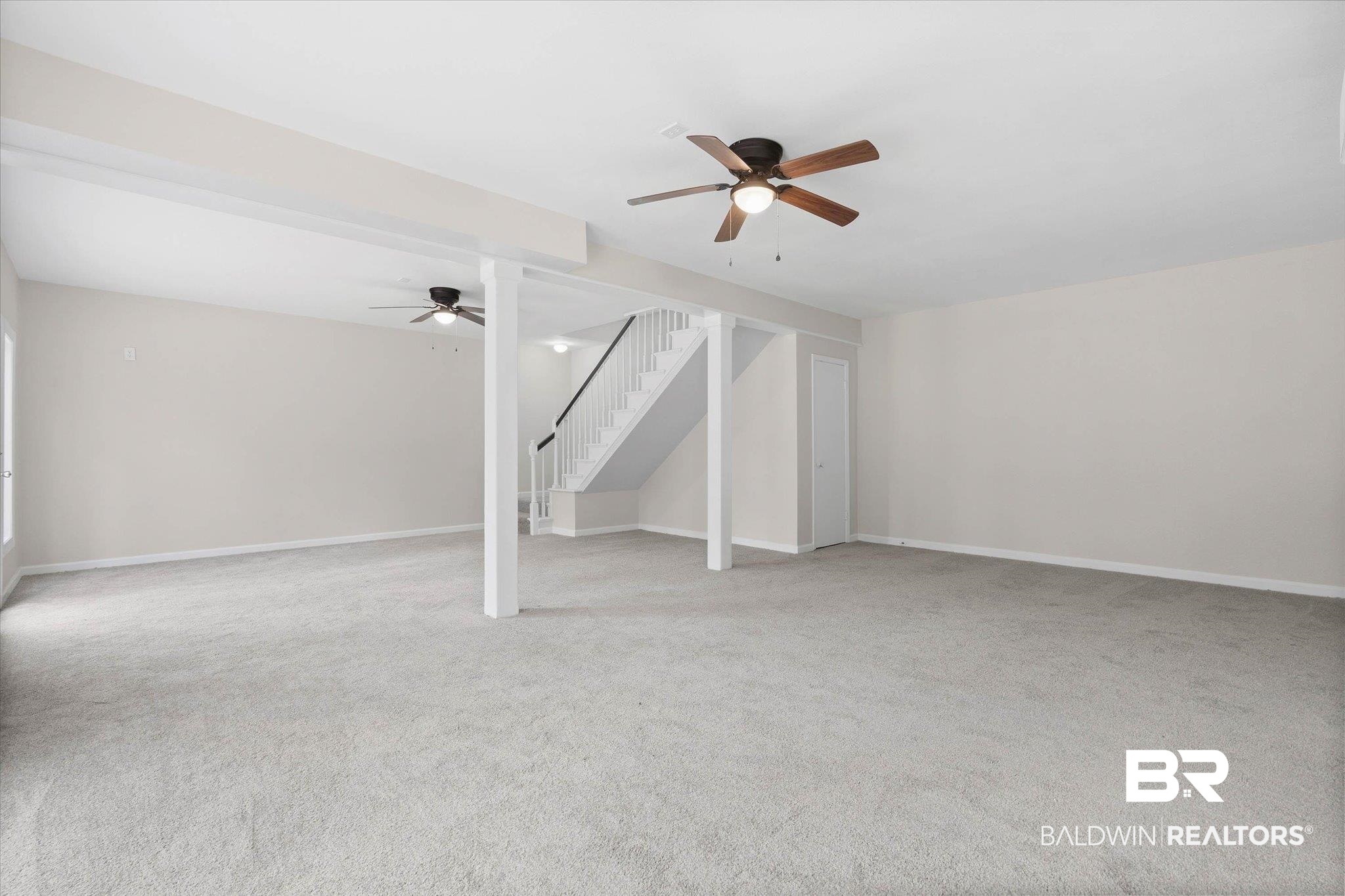 106 Melanie Loop Daphne, AL 36526 - Photo 19 of 45 Unfurnished living room featuring a ceiling fan and light carpet