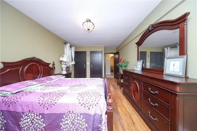 a bedroom with a bed and a dresser