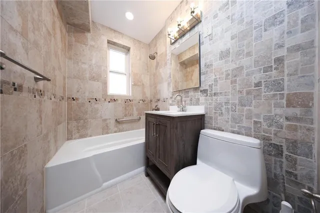 a white toilet sitting next to a bathtub