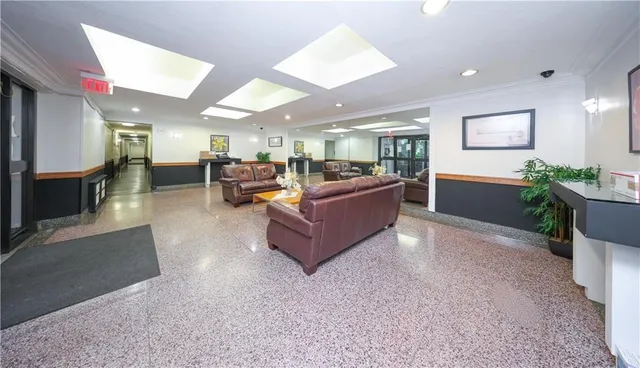 a living room with furniture and a kitchen