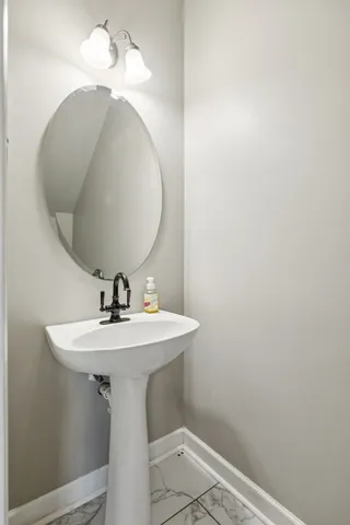 a bathroom with a sink and mirror
