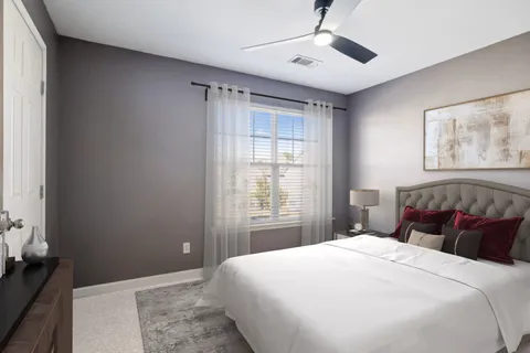 a bedroom with a large bed and a window