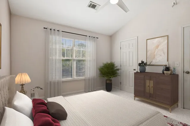 a bedroom with a bed and a window