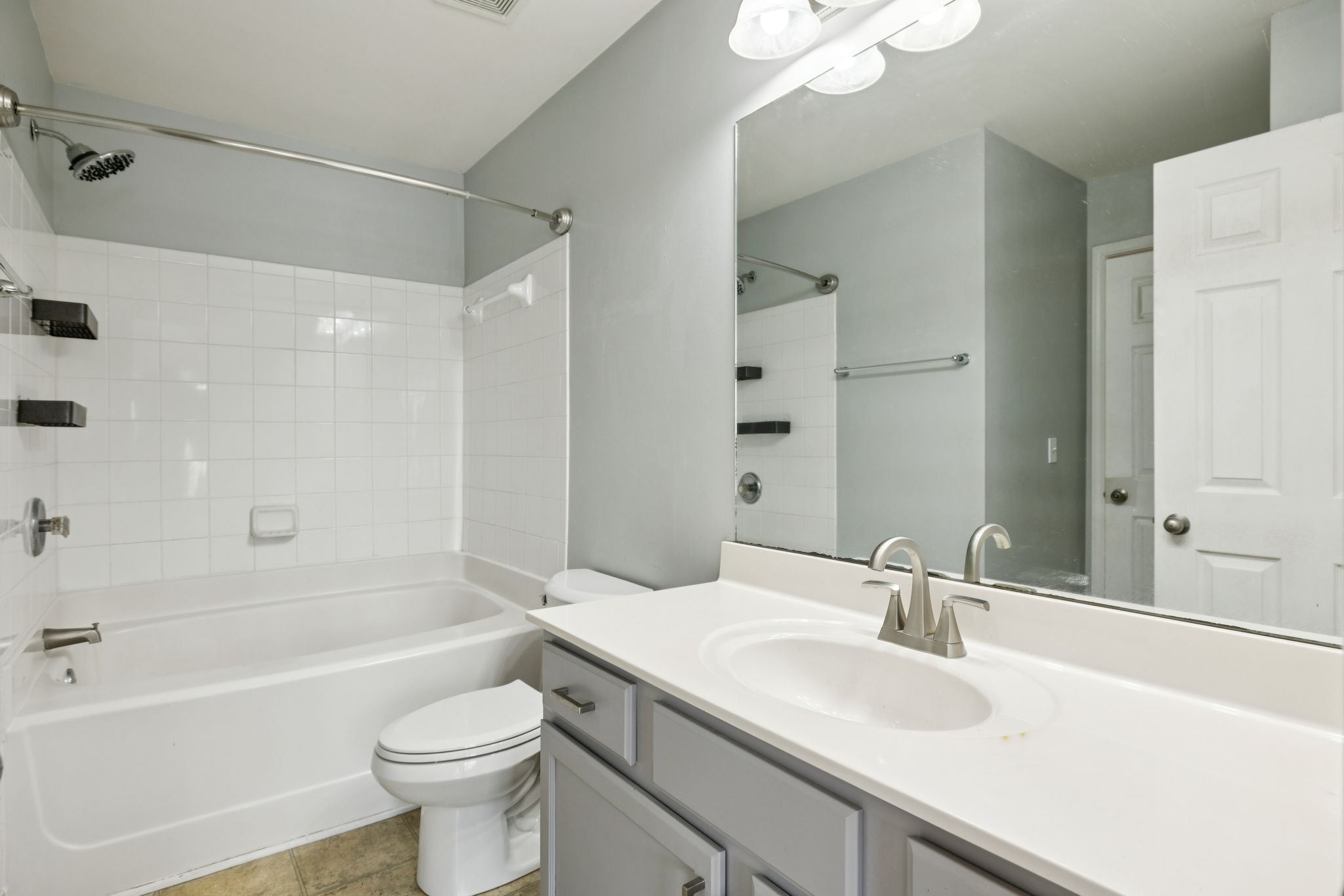 1832 Lincoya Bay Drive Nashville, TN 37214 - Photo 16 of 33 a bathroom with a sink a toilet a mirror a bathtub and shower