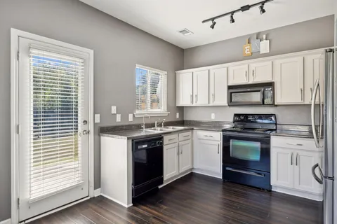 a kitchen with a stove a sink and a microwave