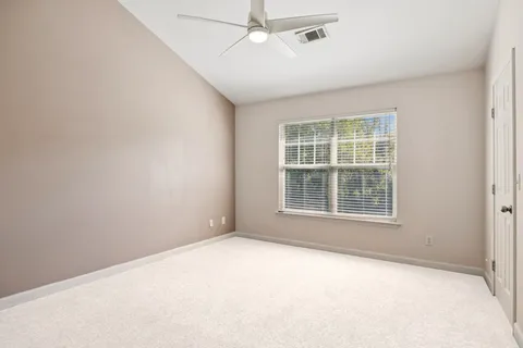 an empty room with a empty space and windows