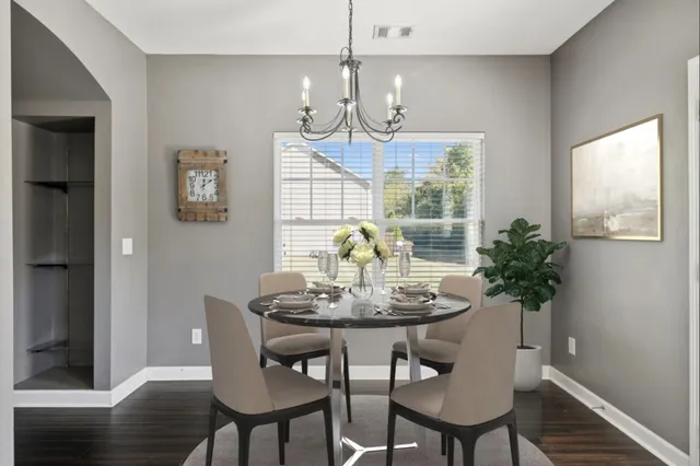 a view of a dining room with furniture wooden floor and chandelier