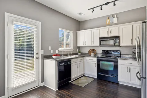 a kitchen with a stove a sink and a microwave