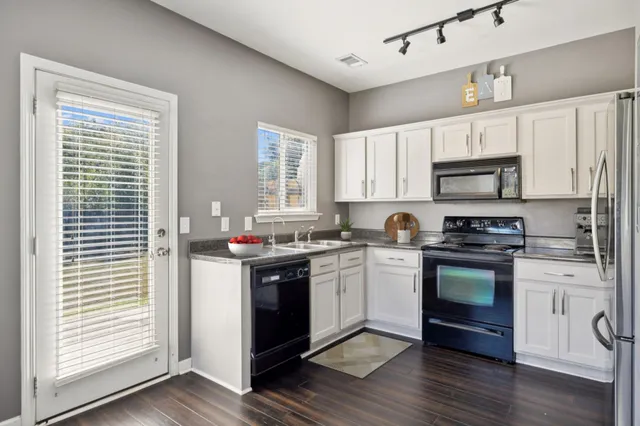 a kitchen with a stove a sink and a microwave